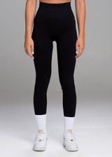 A model wears the Sassy Sportswear Leggings Timeless in the Black Addicted color