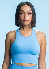 A model wears the Sassy Sportswear Crop Top Candy in the Bluegum color