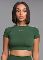 A model wears the Sassy Sportswear Crop Top Timeless in Evergreen color