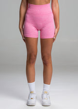A model wears the Sassy Sportswear Shorts Sexyback in the Hot Pink color