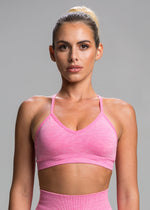 A model wears the Sassy Sportswear Sports Bra Sexyback in the Hotpink color