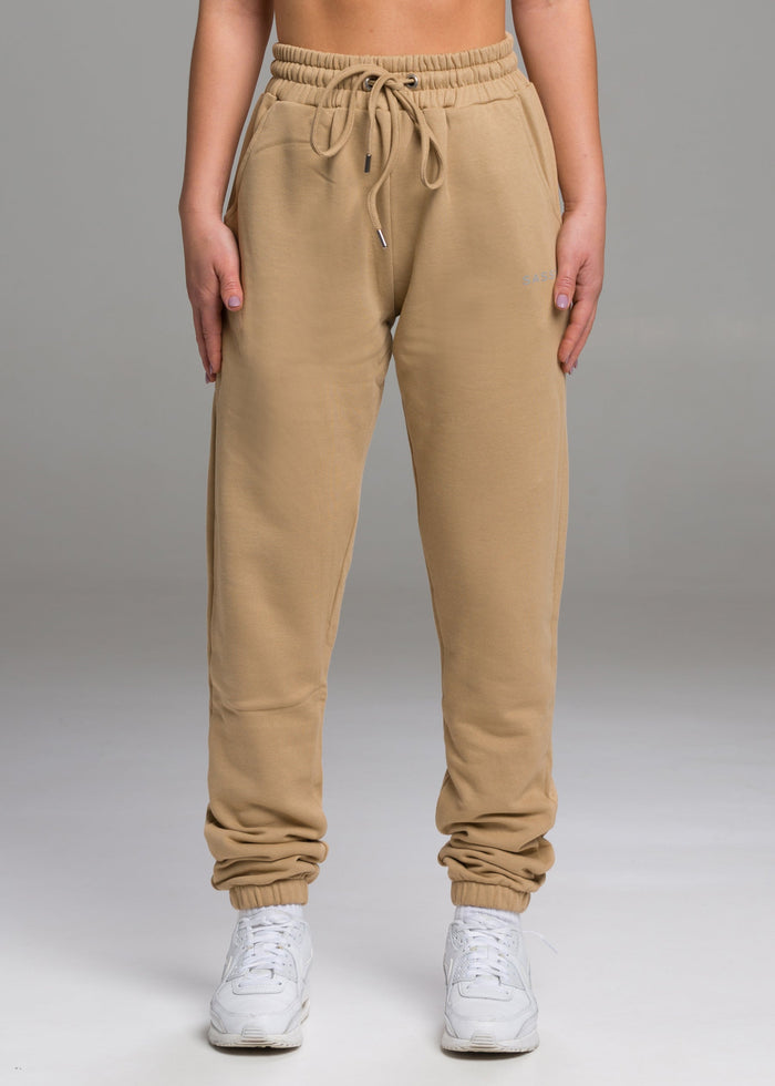 A model wears the Sassy Sportswear Joggers Everyday in the Sand color